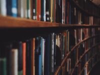brown wooden book shelves with books