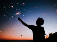 person holding sparkler silhouette